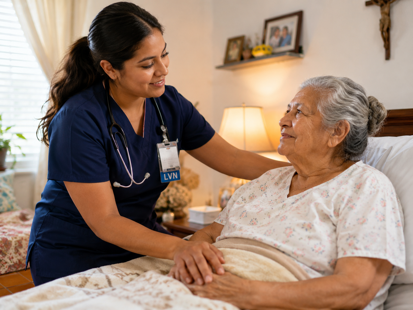 Hispanic LVN providing compassionate home health care to an elderly Hispanic patient in a comfortable home setting.